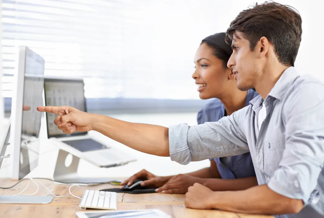 Two colleagues reviewing a security strategy on screen together