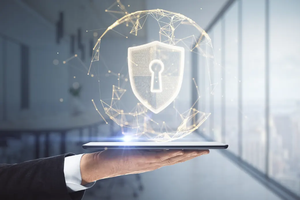 Protective shield icon above a tablet representing vulnerability and threat management