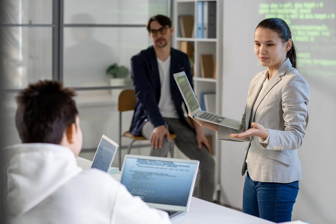 Consultant walking a client team through a recovery plan on a laptop during a working session