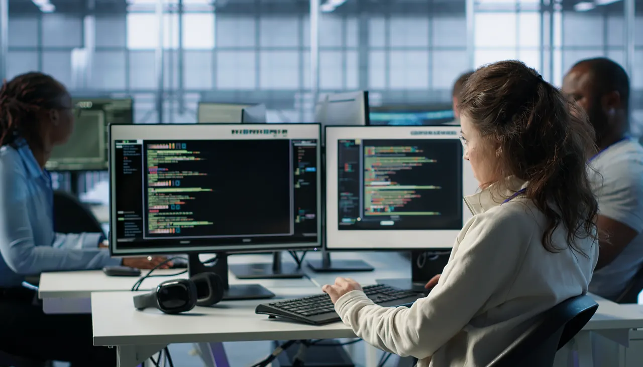 Analysts working across multiple monitors in a security operations centre